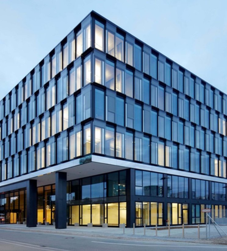 Modern glass office building with a solar-integrated façade by RozhVolt